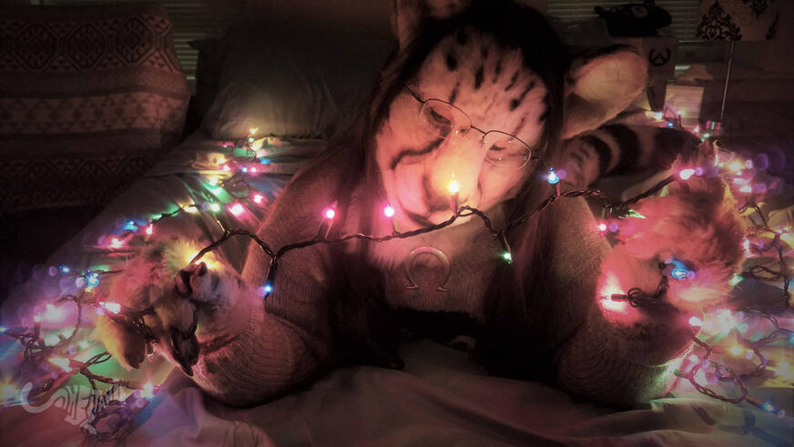 Shetani on a bed in the dark, holding and looking fondly at a string of illuminated fairy lights. Soft and muted colors Shetani on a bed in the dark, holding and looking fondly at a string of illuminated fairy lights. Soft and muted colors