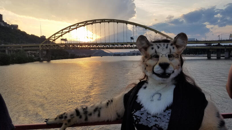 Shetani on the ship at dusk with the sunset behind her and one of Pittsburgh&#39;s famous bridges