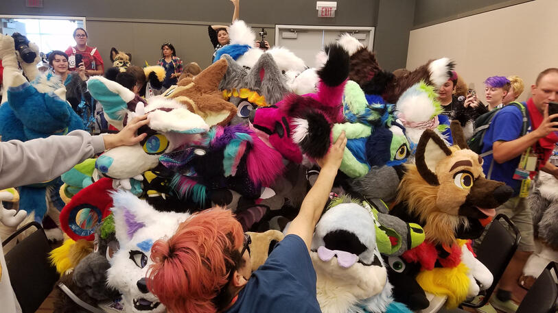 Pile of fursuit heads on table