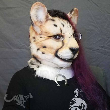 Shetani in fursuit wearing a MCR sweater, her hair dyed in a wine-red gradient and styled like an undercut