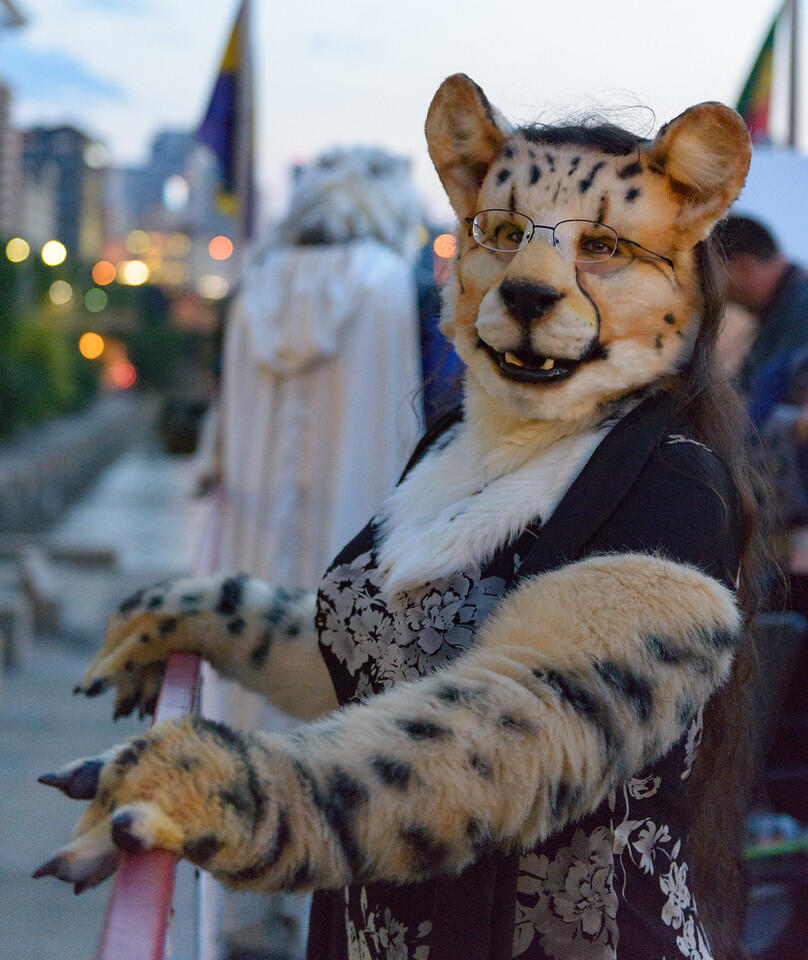 Closeup of Shetani leaning on the railing of a cruise ship