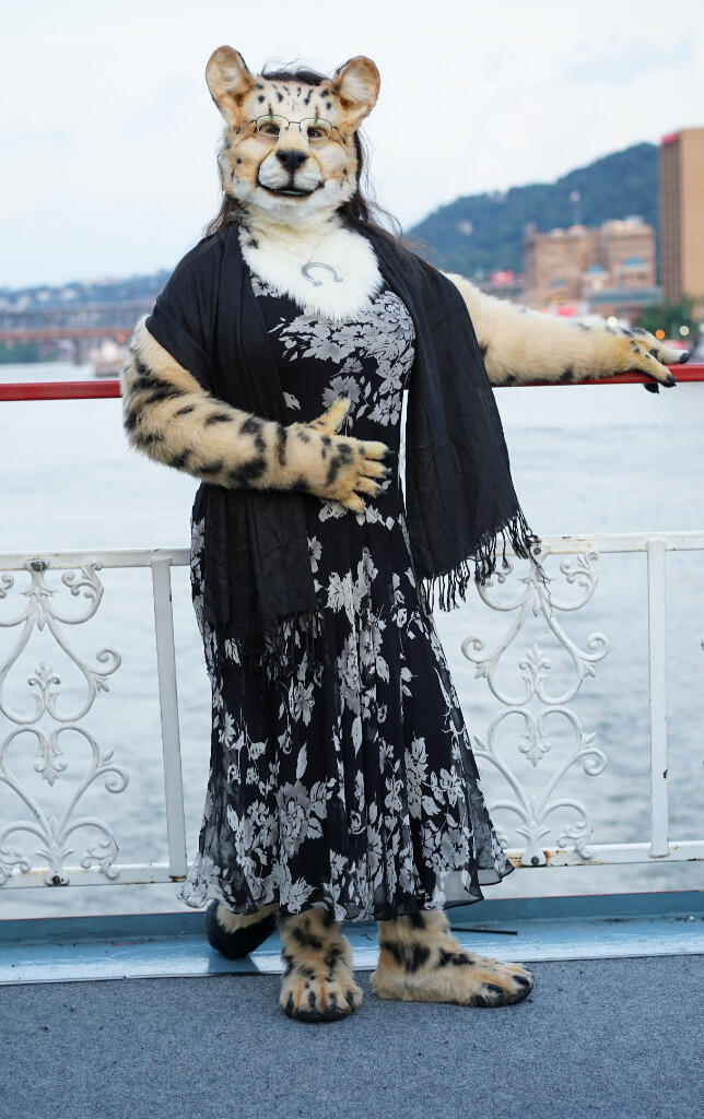 Shetani on a cruise ship wearing a formal black floral print dress &amp; black shawl