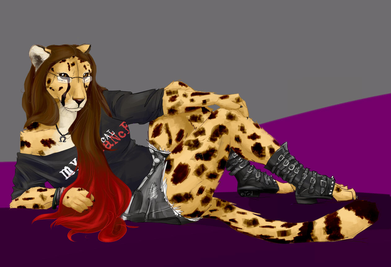 Art of Shetani reclining on one elbow, wearing a MCR shirt and torn black shorts with spiked punk toe-boots, hair dip-dyed red