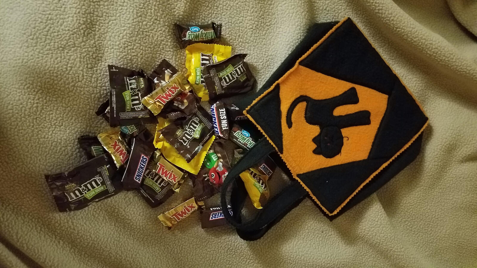 Trick-or-treat bag spilling candy
