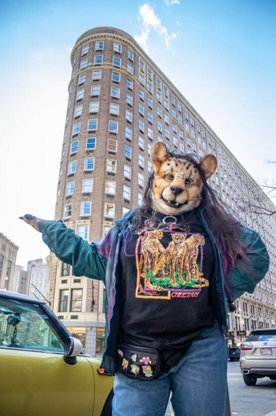 Shetani on the street with cars and the Boston Park Plaza building behind