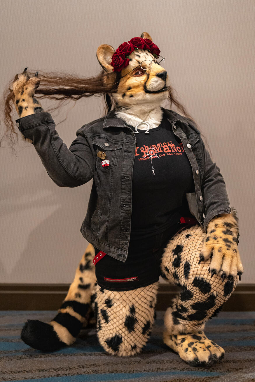 Shetani down on one knee, running her paw through her long wavy hair