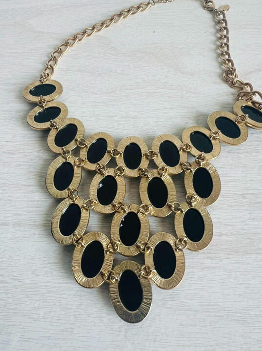 Photo of the back side of the necklace to show that the 4 rows of cabochons are all linked to each other via small gold hoops.